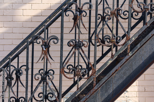 Rusty vintage black forged metal fence. Architecture