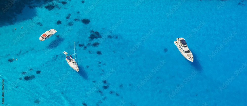 Fototapeta premium Aerial view of yachts in azure sea
