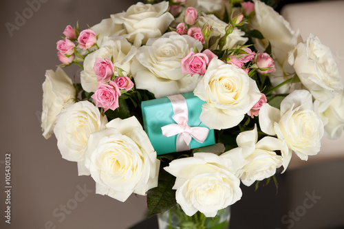 Gift box and bouquet of beautiful roses for holiday. © abelena