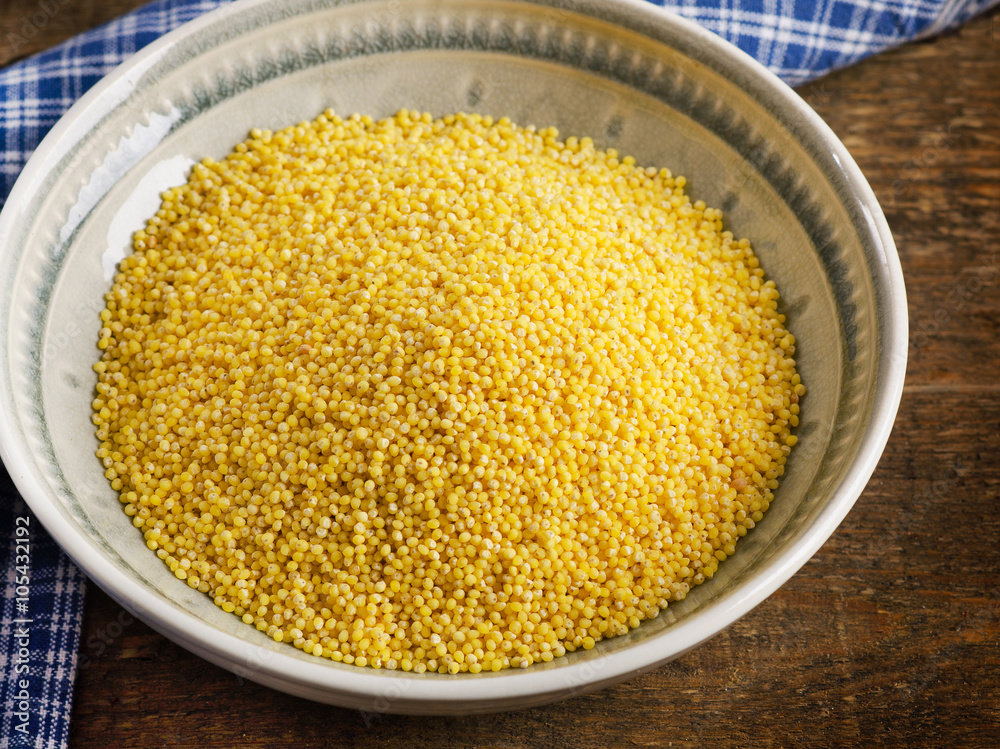 Organic millet in a bowl on wooden rustic table. Organic millet in a bowl on wooden rustic table.