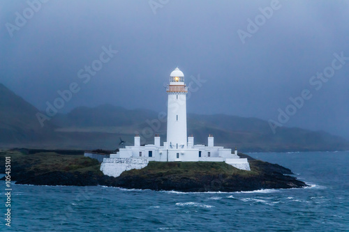Lismore lighthouse in Scotland at dusk photo