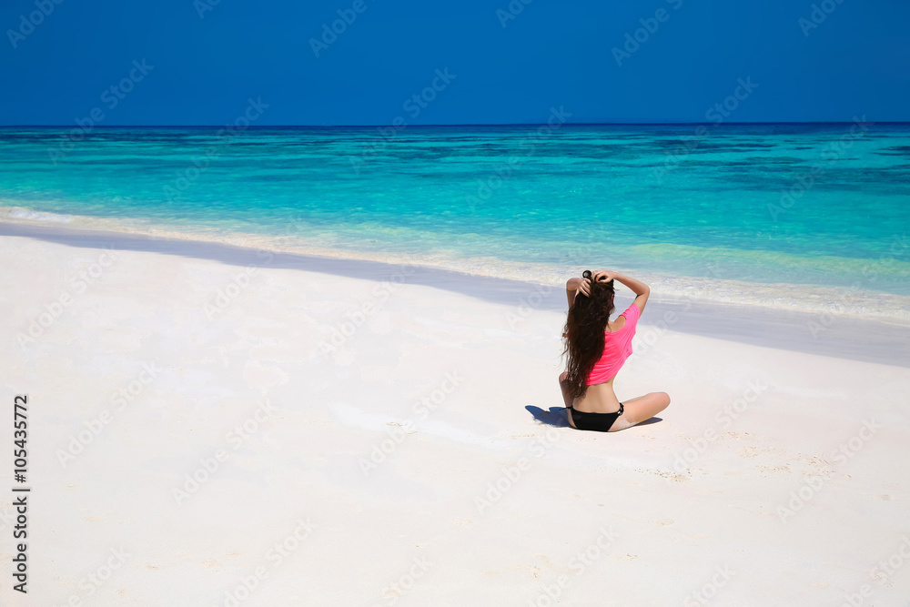 Happy brunette woman enjoying on exotic beach in summer by tropi Happy brunette woman enjoying on exotic beach in summer by tropi