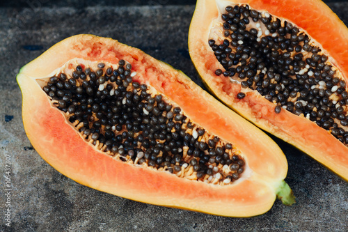 sliced papaya fruit on black background