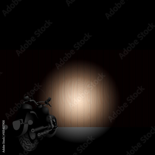 Heavy motorcycle front light on a wooden fence in the night