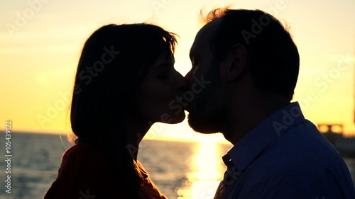 Young couple in love, kissing on beach during sunset, super slow motion 240fps
