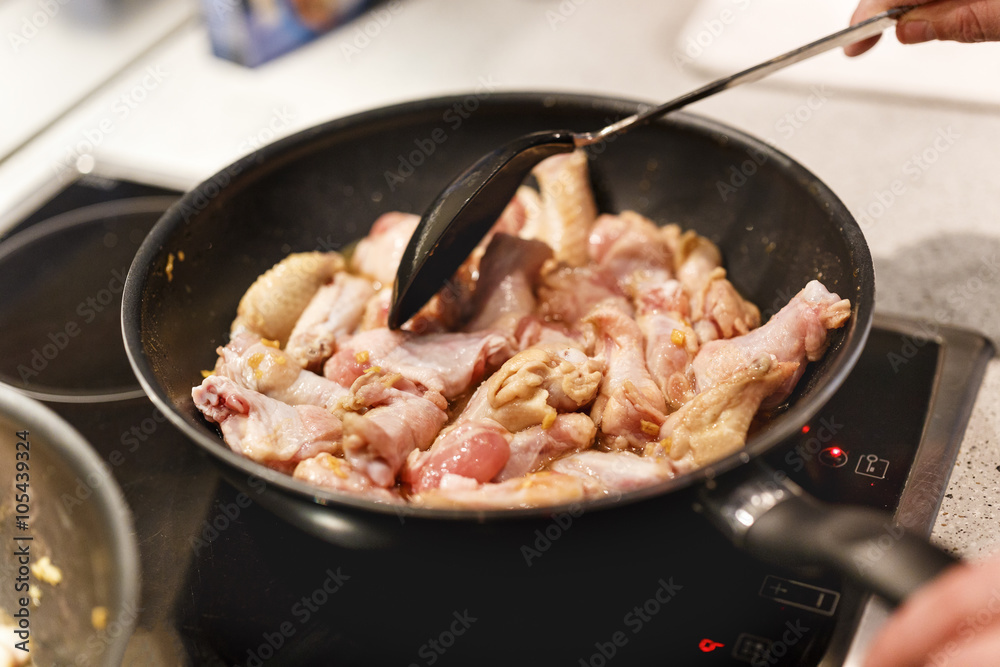pan with chicken wings on the stove pan with chicken wings on the stove