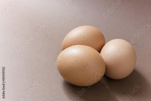 Brown eggs on a brown background