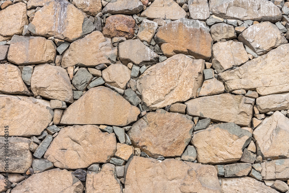 Natural dry stone wall. The structures are constructed from stones or rocks without any mortar to bind them together Natural dry stone wall. The structures are constructed from stones or rocks without any mortar to bind them together