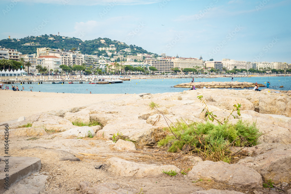 People on the most popular beach in Cannes, France - Plage de la Croisette - the famous beach on the Croisette, known for its film festival.