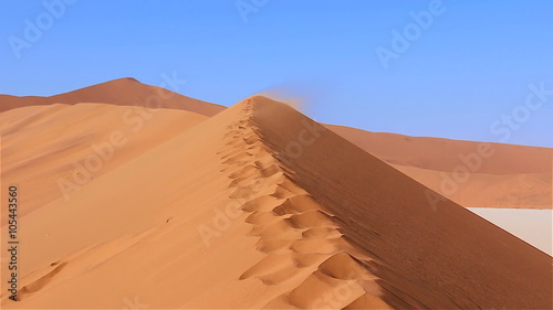 Zoom in moving over sanddune with sandstorm Sossusvlei Namibia Africa
