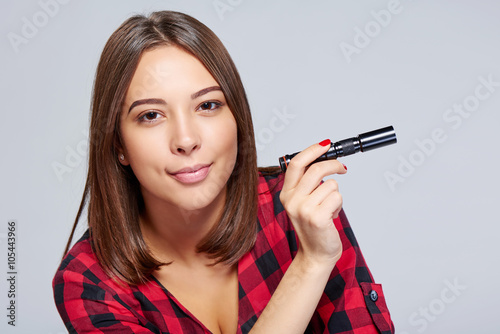 Closeup of smiling female holding pocket flashlight