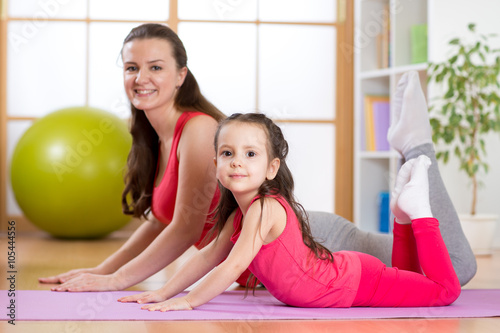 Mom and kid do gymnastics. ...