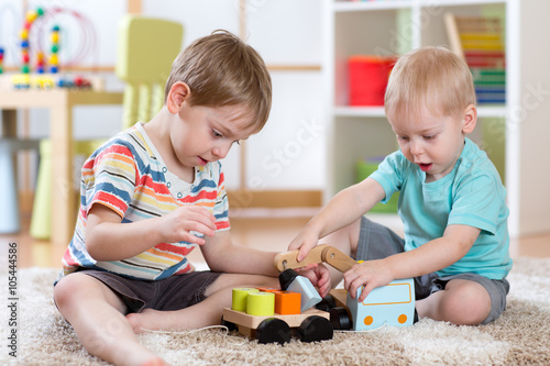 Children playing car toy in...