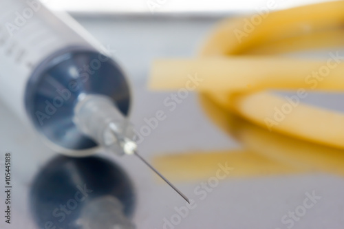 syringe and tourniquet on the tray  photo