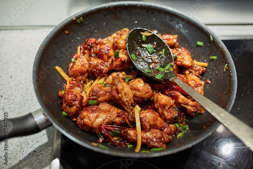 Chicken wings in a wok