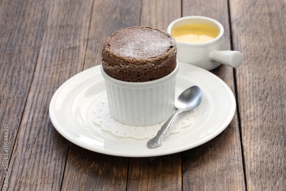 freshly baked chocolate souffle with creme anglaise, french dessert freshly baked chocolate souffle with creme anglaise, french dessert