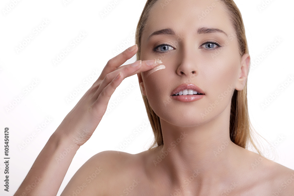 Closeup of beautiful model applying her skin treatment
