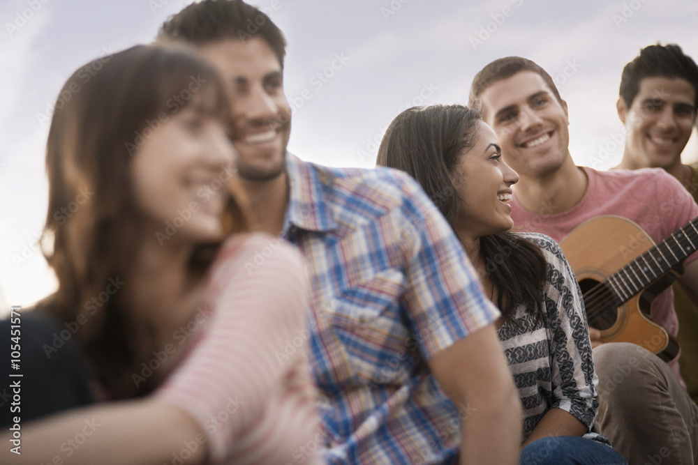 A group of people, men and women gathered together, A group of people, men and women gathered together,