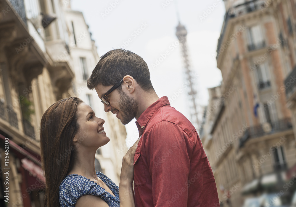 A couple, a man and woman looking into each other's eyes on a city street, A couple, a man and woman looking into each other's eyes on a city street,