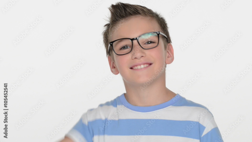 Happy expressive caucasian boy showing in the camera the thumbs up sign at studio Happy expressive caucasian boy showing in the camera the thumbs up sign at studio