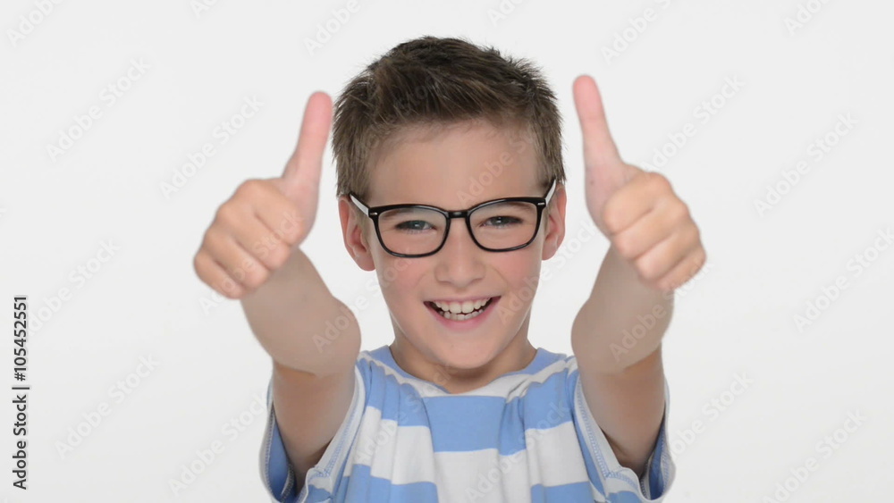 Happy expressive caucasian boy showing in the camera the thumbs up sign at studio Happy expressive caucasian boy showing in the camera the thumbs up sign at studio