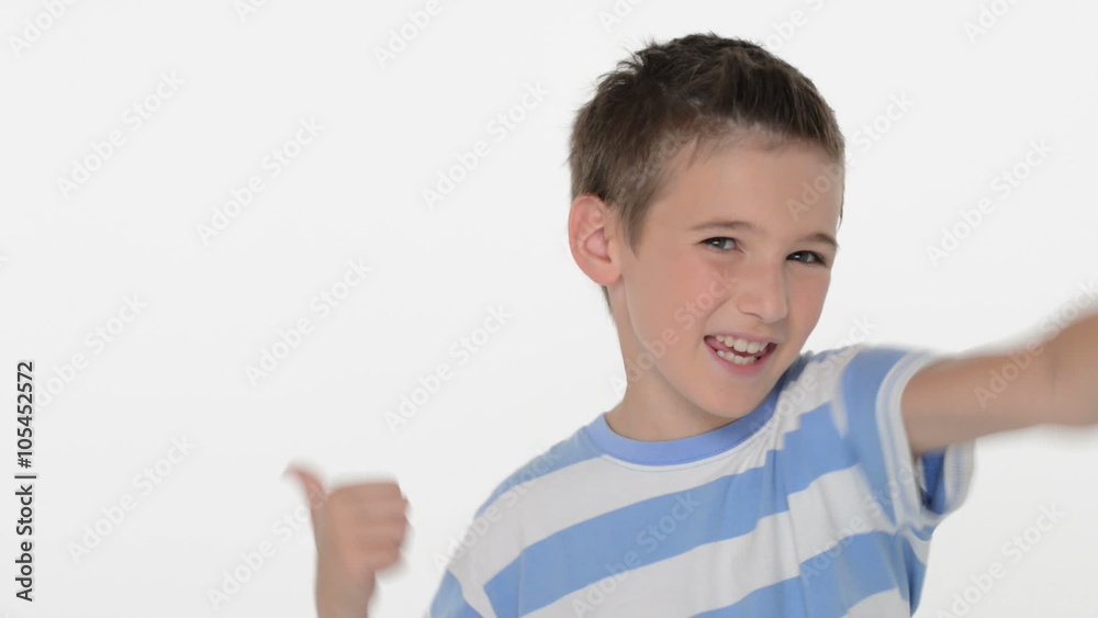 Happy expressive caucasian boy showing in the camera the thumbs up sign at studio Happy expressive caucasian boy showing in the camera the thumbs up sign at studio