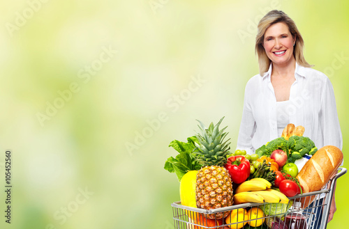 Beautiful senior woman with grocery shopping cart.