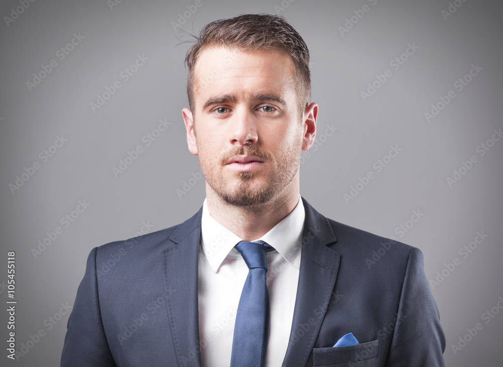 Portrait of a serious businessman on grey background