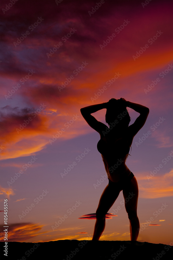 silhouette of woman in bikini stand up hands by head