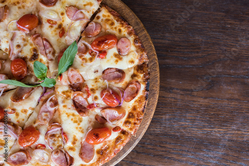 spicy sausage pizza on wooden table, Top view