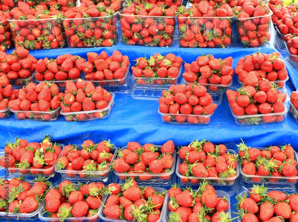 Strawberries ripe spring in containers in the market