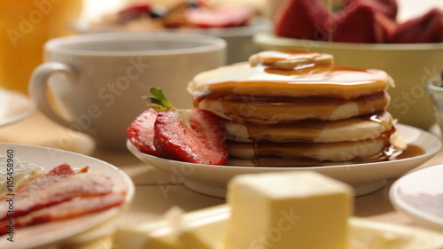 Pouring syrup on pancakes