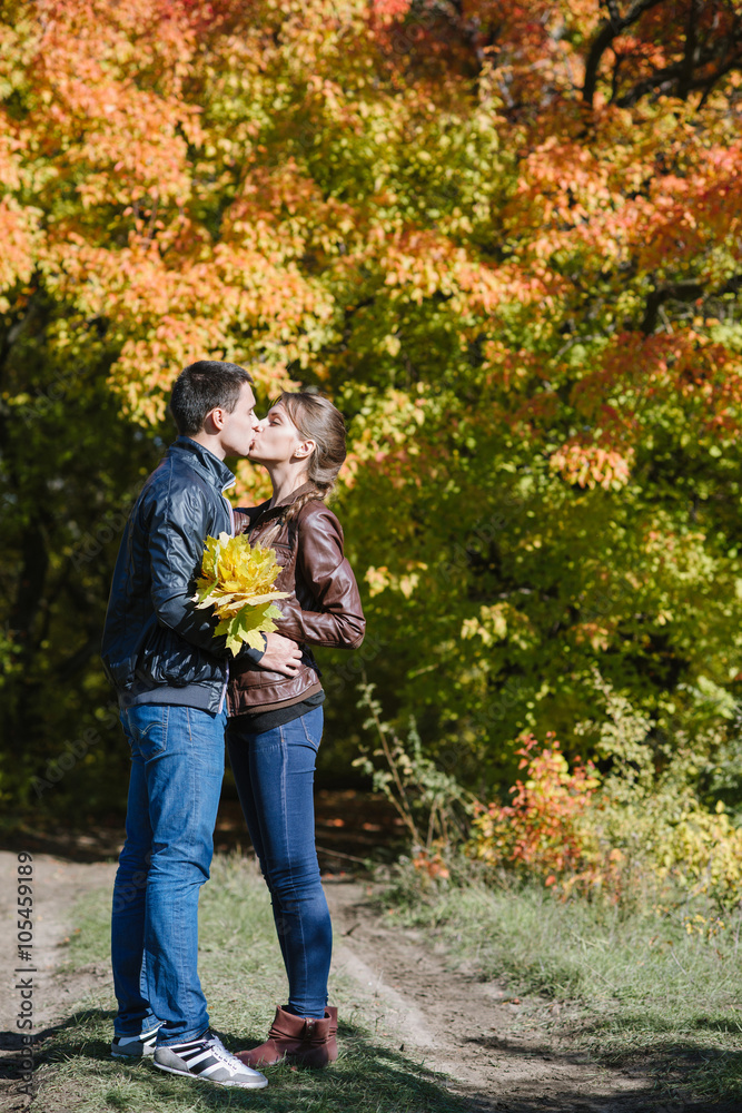 young couple in love, kiss, autumn vivid landscape young couple in love, kiss, autumn vivid landscape
