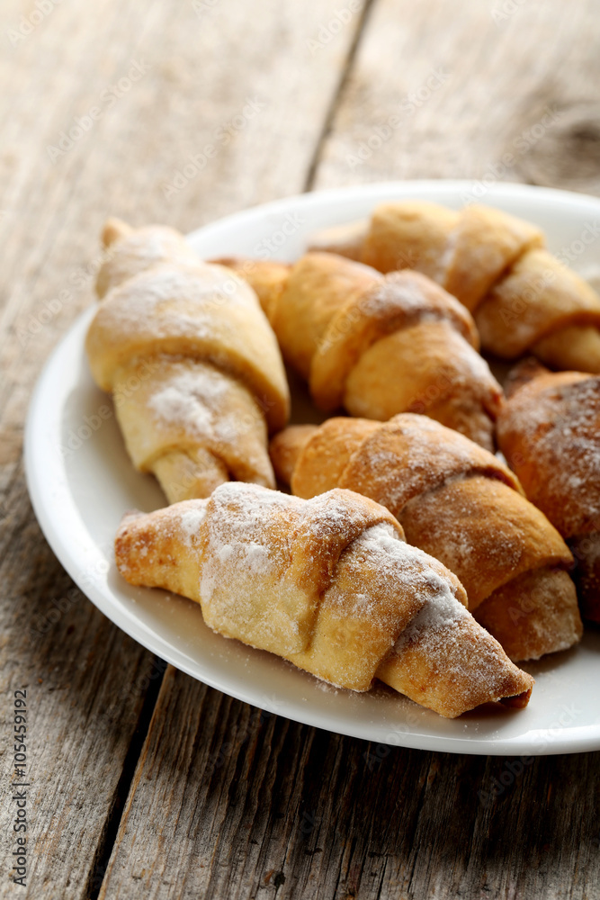 Fresh homemade croissants on a grey wooden table