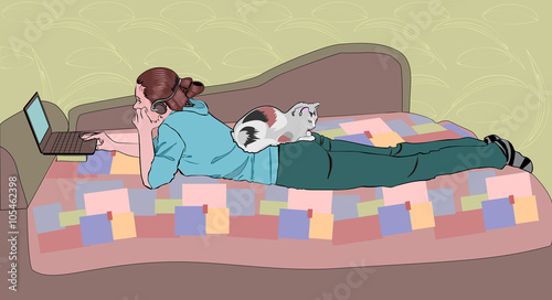 Girl with a laptop and a cat at home on the couch.