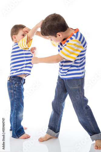 Two boys fighting isolated in white