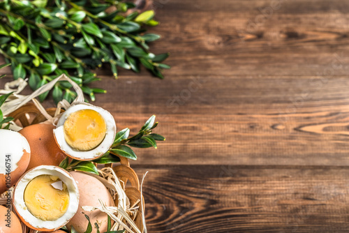 Easter eggs in easter basket on wooden background.