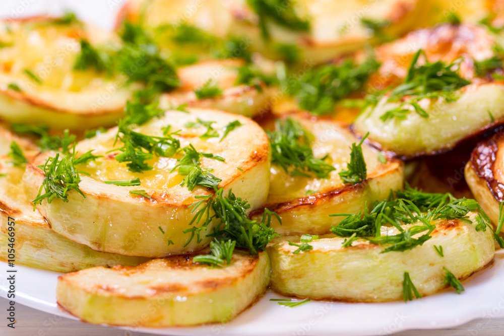 Appetizing vegetable marrows, fried in oil and strewed with gree