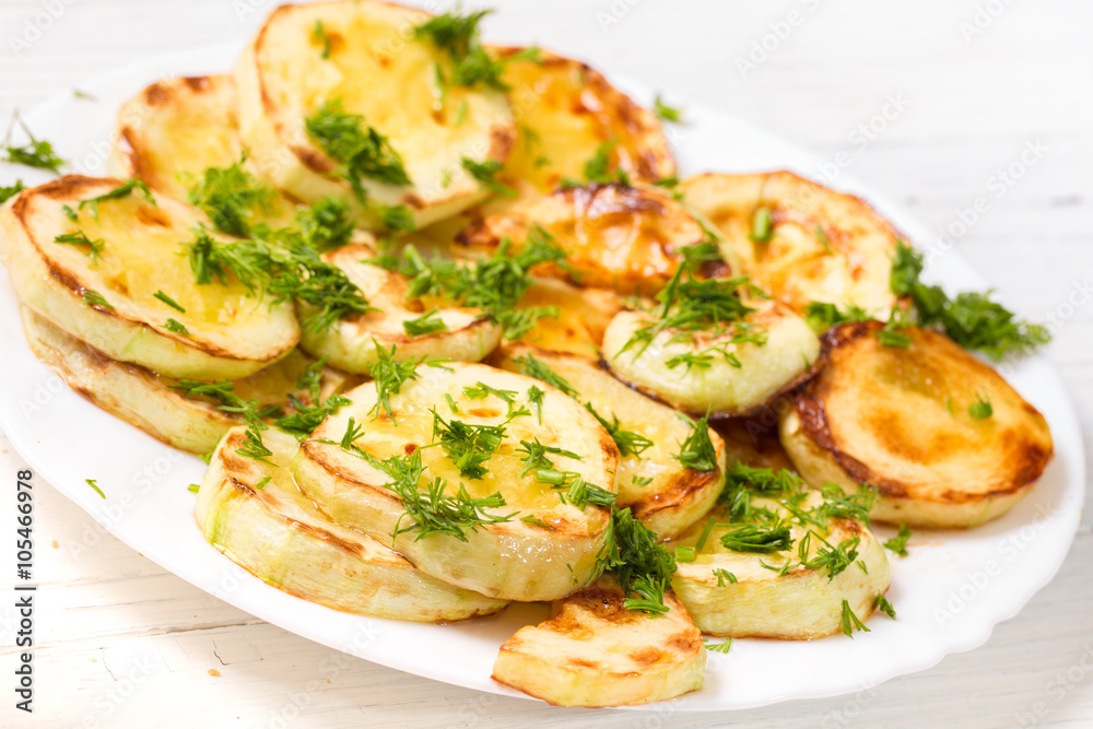 Appetizing vegetable marrows, fried in oil and strewed with gree Appetizing vegetable marrows, fried in oil and strewed with gree