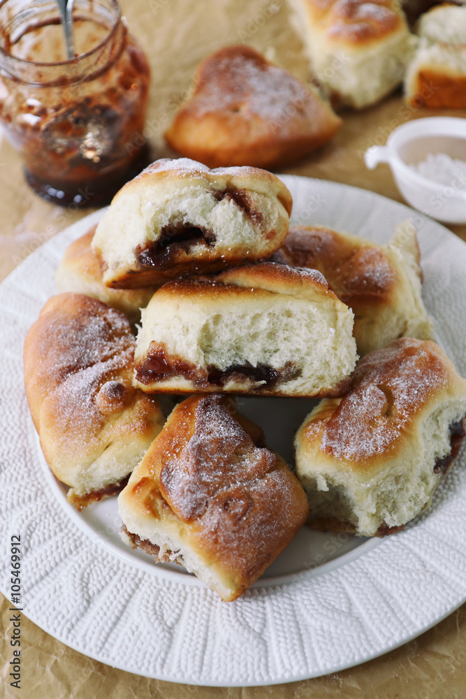 Tasty buns filled with berry jam served on white plate