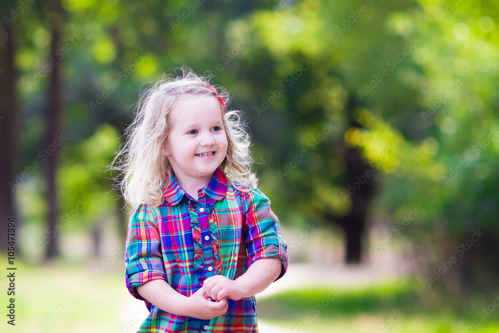 Little girl running in autumn park Little girl running in autumn park