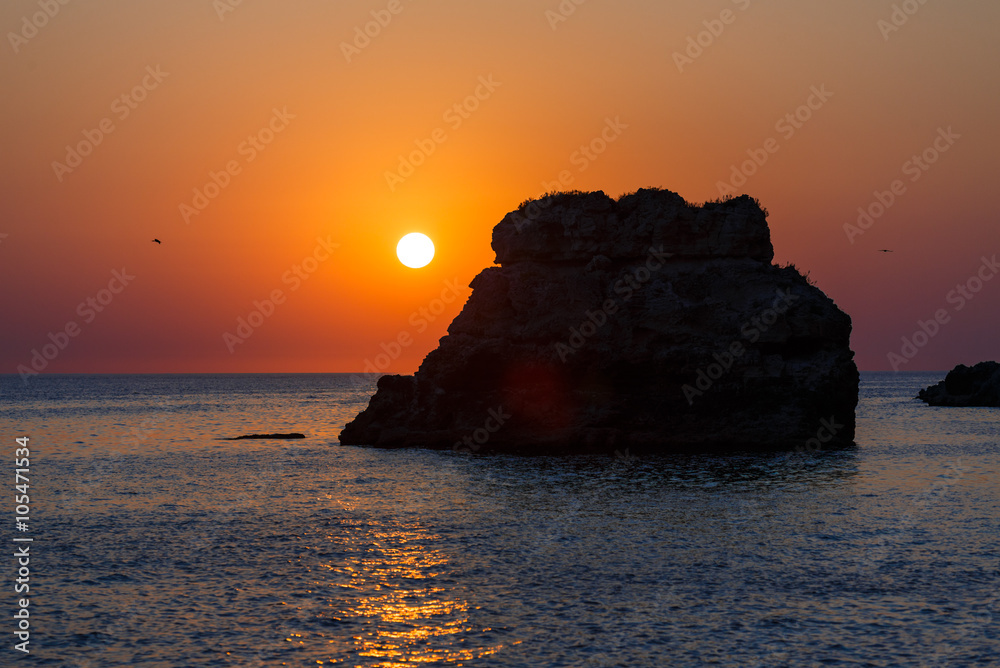 Sunset on the rocky seashore