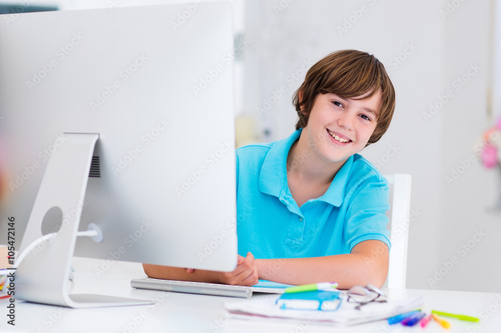 Boy doing homework with modern computer Boy doing homework with modern computer