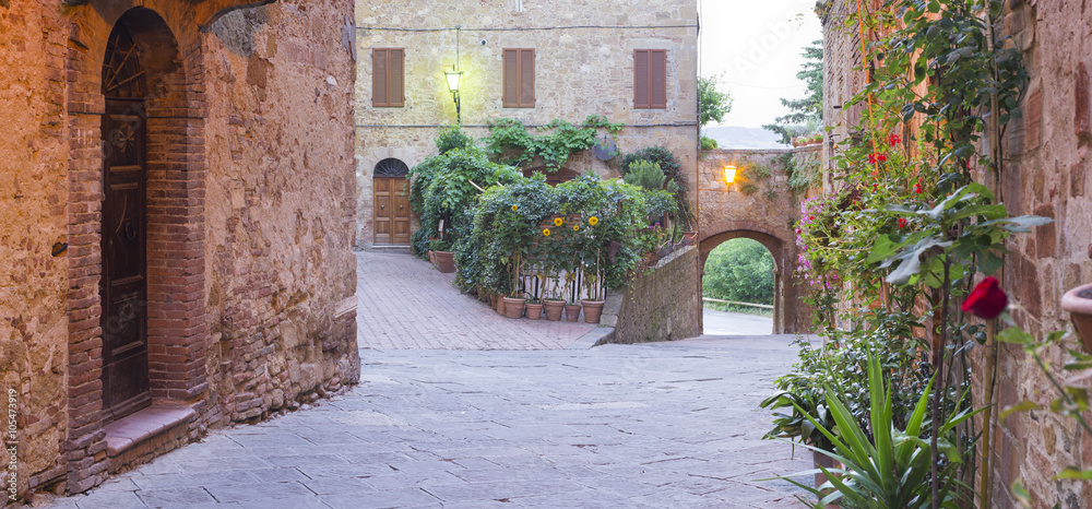 Fototapeta premium walls and lonely street early in the morning in tuscany city in Italy
