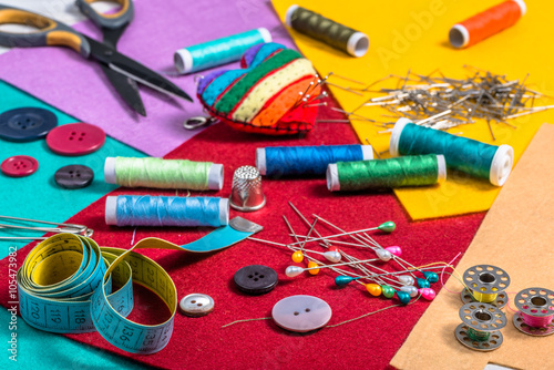 Various sewing accessories on a colored felt. photo