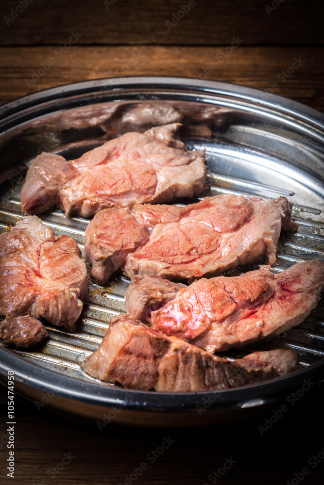 Beef steak in a frying pan.