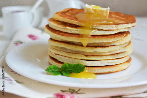 Pancakes for breakfast with butter and honey