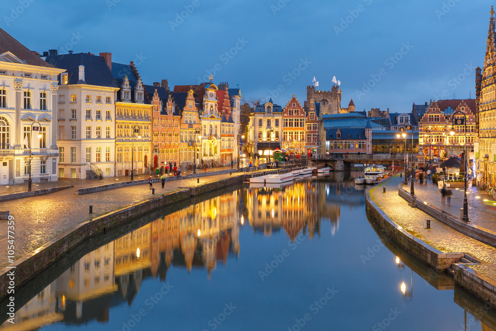 Picturesque medieval buildings on quay Korenlei and  quay Graslei,  Leie river in the evening, blue hour, Ghent, Belgium