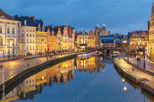 Picturesque medieval buildings on quay Korenlei and quay Graslei, Leie river in the evening, blue hour, Ghent, Belgium