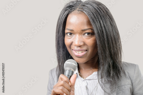 young African american journalist with a microphone